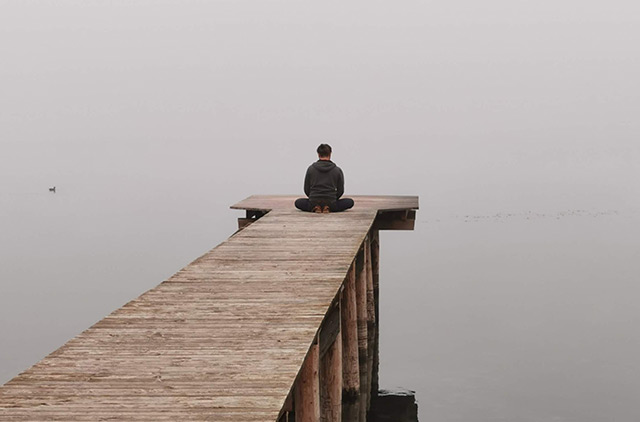 meditating on a pier