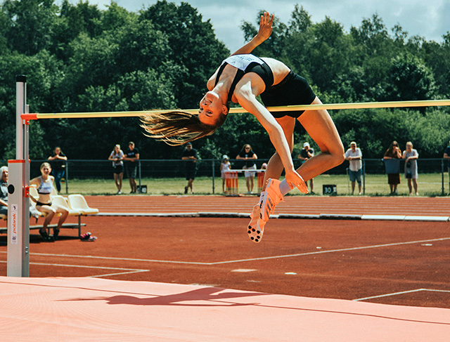 a high jumper clears the bar