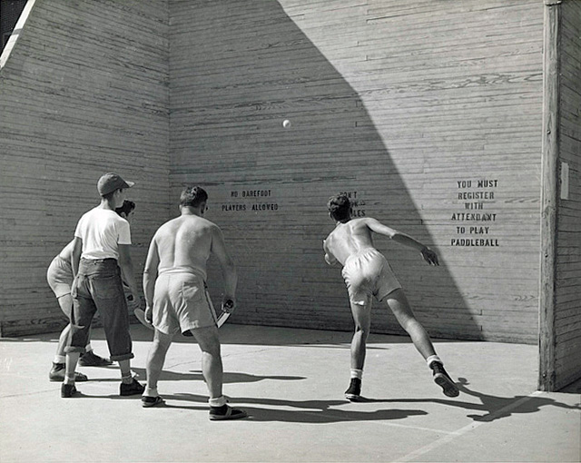 men playing a paddleball game