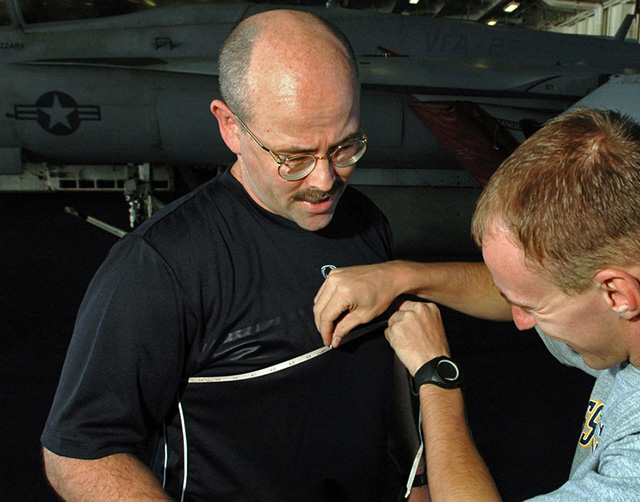 measuring chest girth with tape measure at sternum level