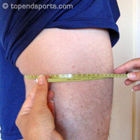 Upper thigh girth measurement technique showing tape placement 1cm below gluteal fold
