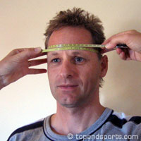 Head girth measurement technique showing tape placement above eyebrows